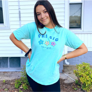 Phi Sigma member wearing a Life is Good t-shirt with image of three flowers